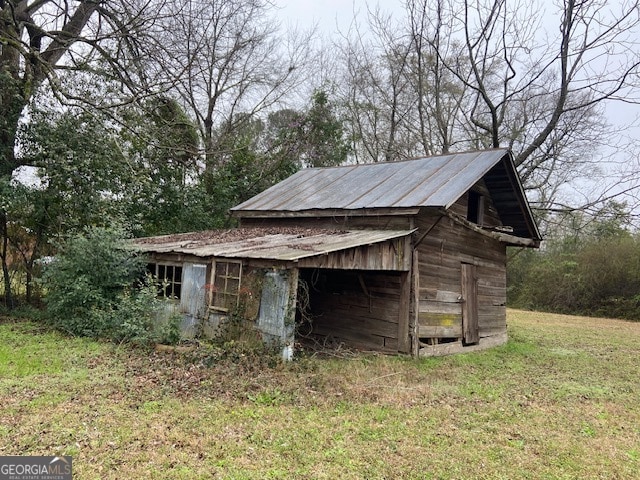 view of outbuilding featuring a yard