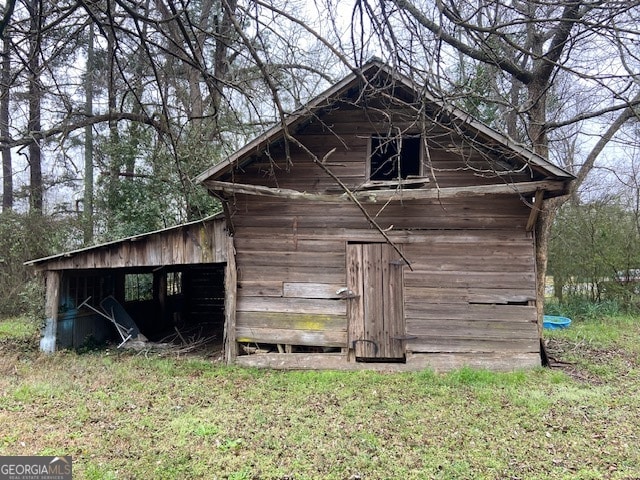 view of outbuilding with a lawn