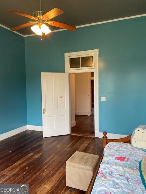 unfurnished bedroom with crown molding, ceiling fan, and dark hardwood / wood-style flooring