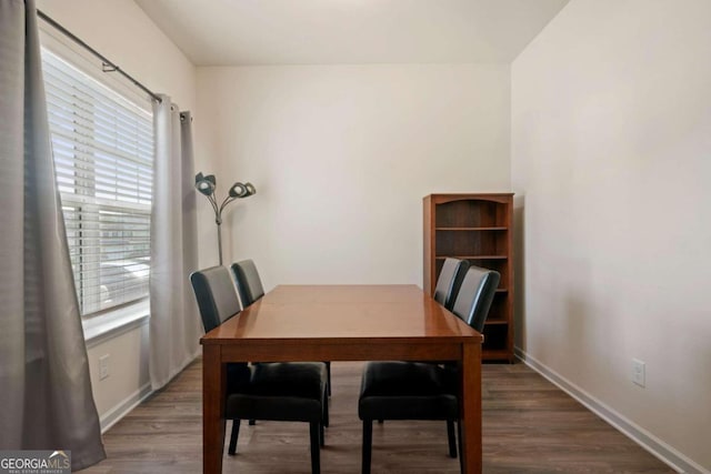 dining space featuring a healthy amount of sunlight and dark hardwood / wood-style flooring