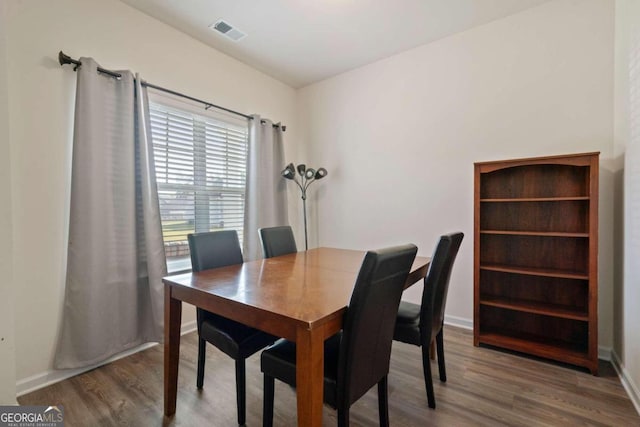 dining area featuring wood-type flooring