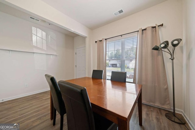 dining space with dark wood-type flooring