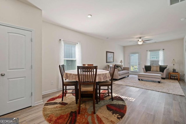 dining room with a wealth of natural light, light hardwood / wood-style flooring, and ceiling fan