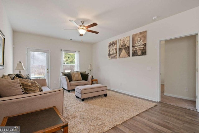 living room with hardwood / wood-style floors and ceiling fan