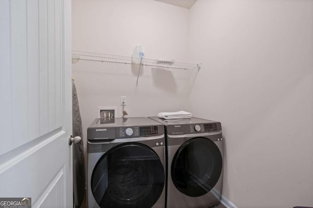 washroom featuring washer and clothes dryer