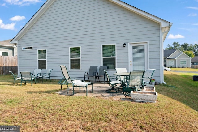 back of property featuring a lawn and a patio area