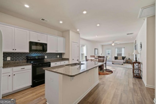 kitchen featuring white cabinetry, sink, black appliances, and light hardwood / wood-style floors