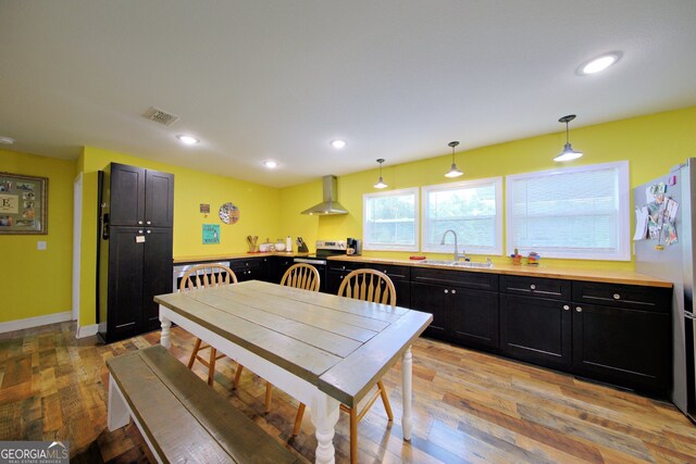 dining space with light hardwood / wood-style floors and sink