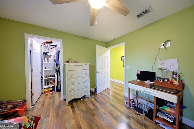 office space with dark wood-type flooring and ceiling fan