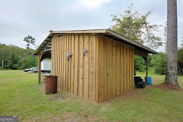 view of outbuilding with a yard