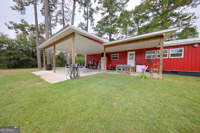 rear view of property with a yard and a patio