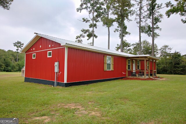 view of outdoor structure featuring a lawn