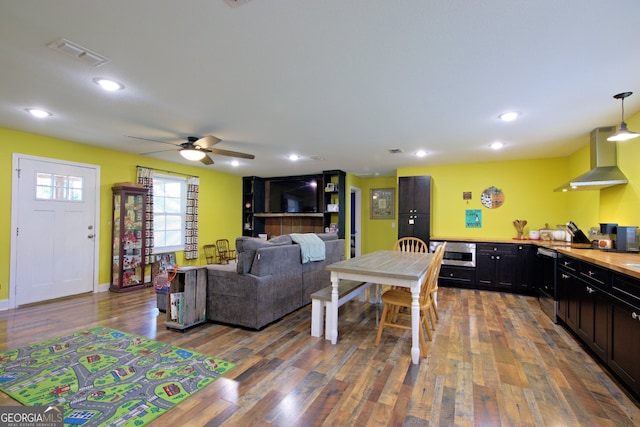 living room featuring ceiling fan and hardwood / wood-style flooring