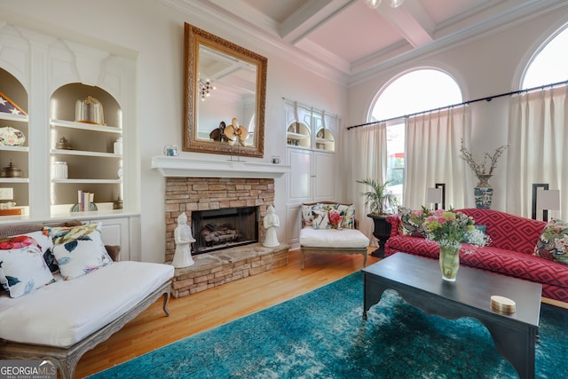 living room with hardwood / wood-style flooring, a fireplace, beamed ceiling, coffered ceiling, and ornamental molding