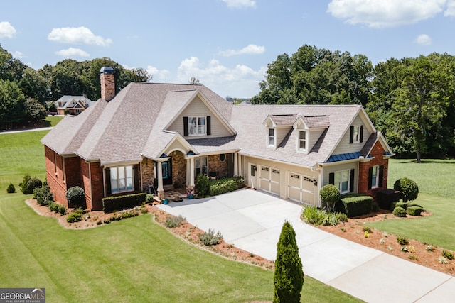 view of front of home with a garage and a front lawn