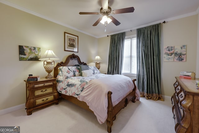 carpeted bedroom with ceiling fan and ornamental molding