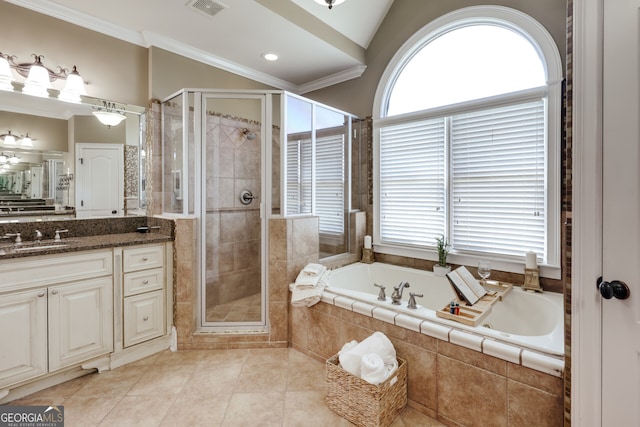 bathroom with vanity, a healthy amount of sunlight, separate shower and tub, and tile patterned floors