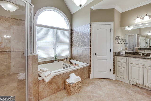 bathroom with plus walk in shower, tile patterned flooring, vaulted ceiling, and vanity