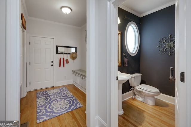 foyer entrance featuring ornamental molding and light wood-type flooring