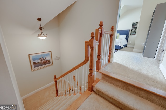 staircase with carpet flooring and vaulted ceiling