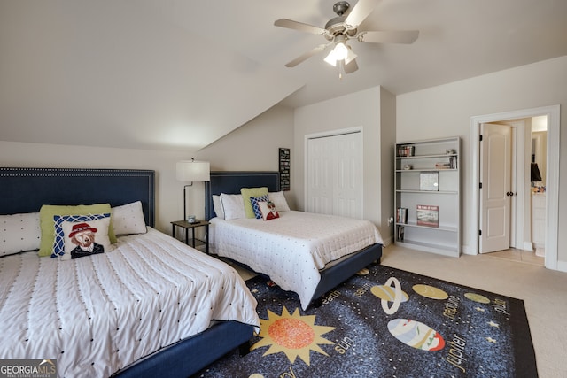 carpeted bedroom featuring lofted ceiling, ceiling fan, and a closet