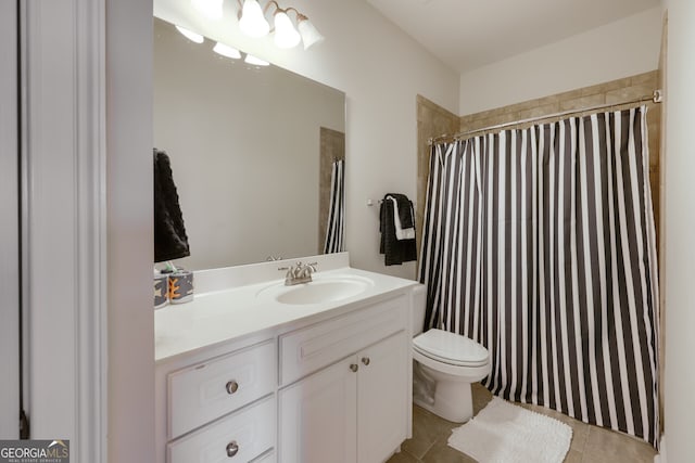 bathroom with vanity, toilet, walk in shower, and tile patterned flooring