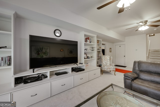 carpeted living room with ceiling fan