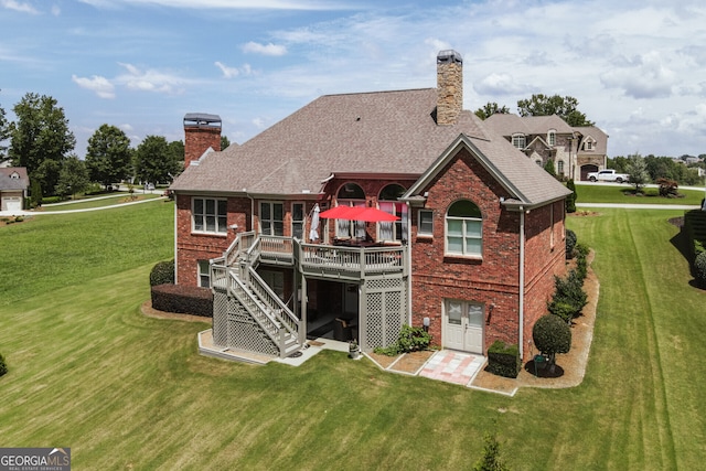 rear view of house with a lawn and a deck