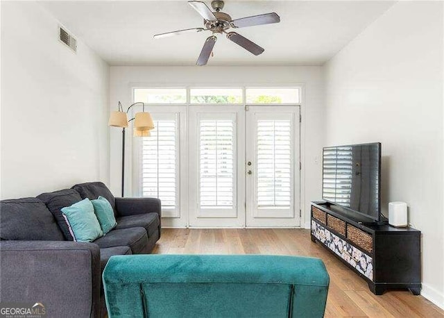 living room with ceiling fan and light hardwood / wood-style floors