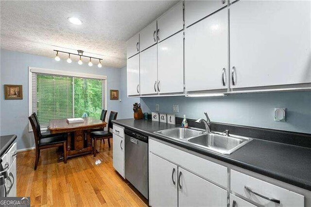 kitchen featuring stainless steel appliances, dark countertops, and white cabinets