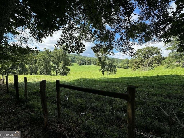 view of gate with a yard