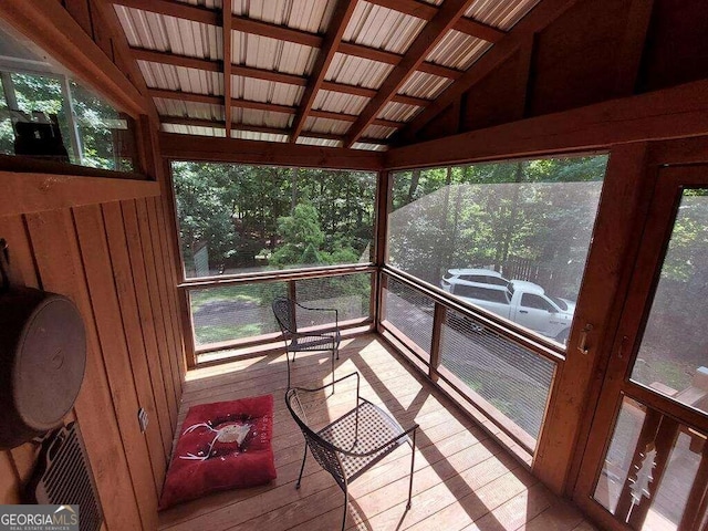 sunroom / solarium featuring vaulted ceiling