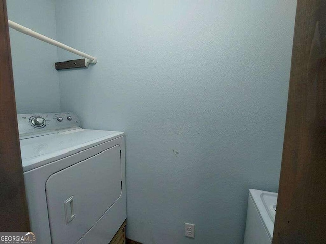 laundry room featuring washing machine and clothes dryer