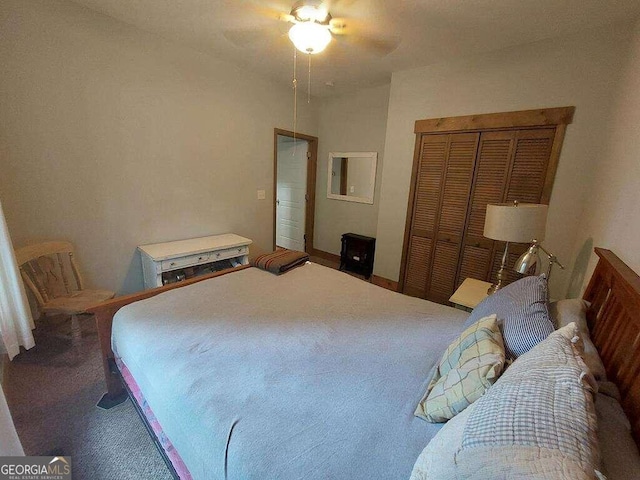 carpeted bedroom with ceiling fan and a closet