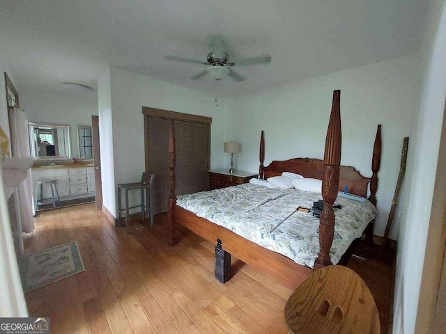 bedroom featuring ceiling fan, a closet, and wood-type flooring