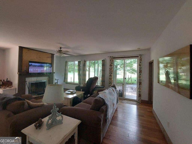 living room with ceiling fan, hardwood / wood-style flooring, and a fireplace