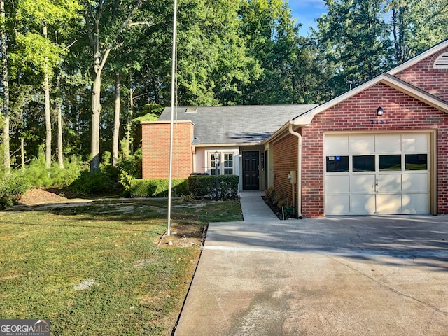 view of front of house featuring a garage and a front lawn