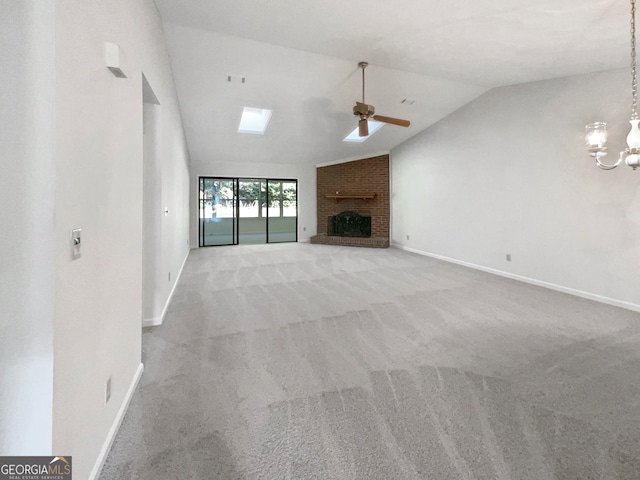 unfurnished living room with lofted ceiling, light colored carpet, ceiling fan with notable chandelier, and a fireplace