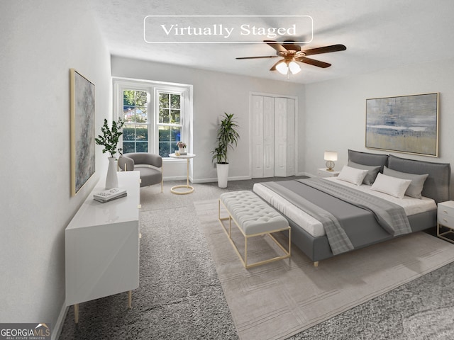 carpeted bedroom featuring ceiling fan and a closet