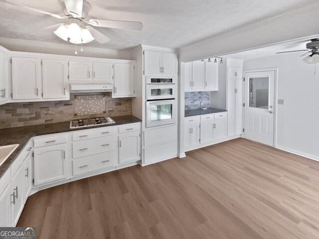 kitchen featuring ceiling fan, sink, white appliances, and white cabinets