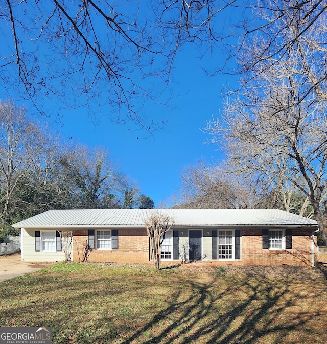 ranch-style home with a front lawn