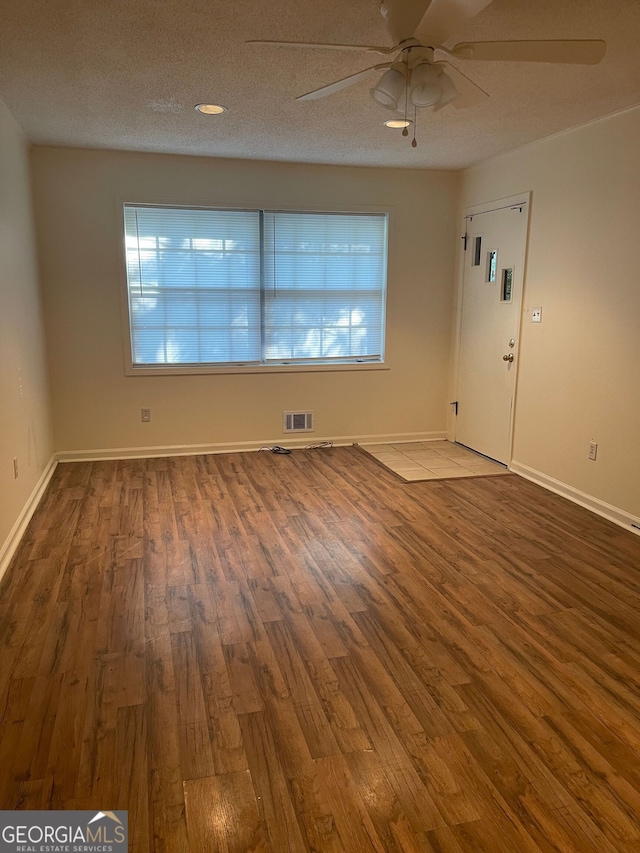 unfurnished room featuring a textured ceiling, ceiling fan, and wood-type flooring