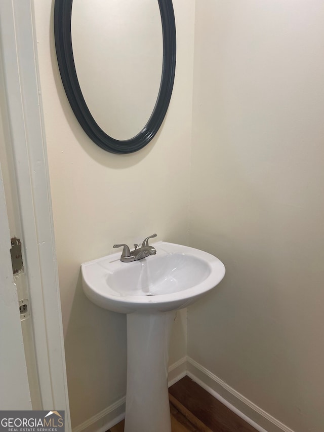 bathroom with hardwood / wood-style floors