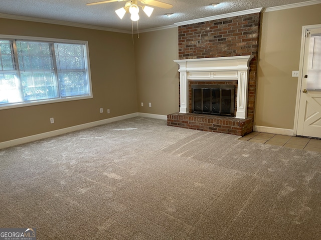 unfurnished living room featuring ceiling fan, light colored carpet, a fireplace, and a textured ceiling