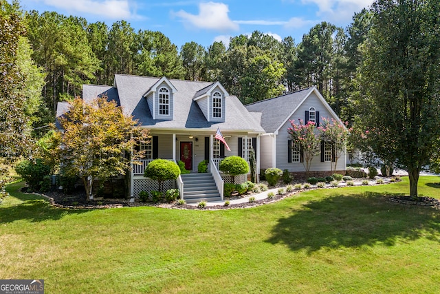 cape cod-style house featuring a porch and a front lawn