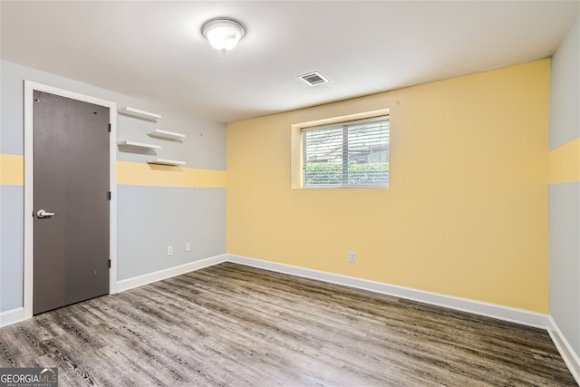 unfurnished room with wood-type flooring