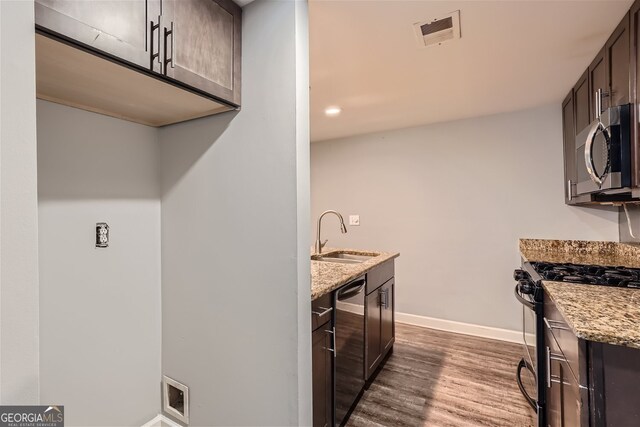 kitchen featuring stainless steel appliances, sink, and dark brown cabinetry