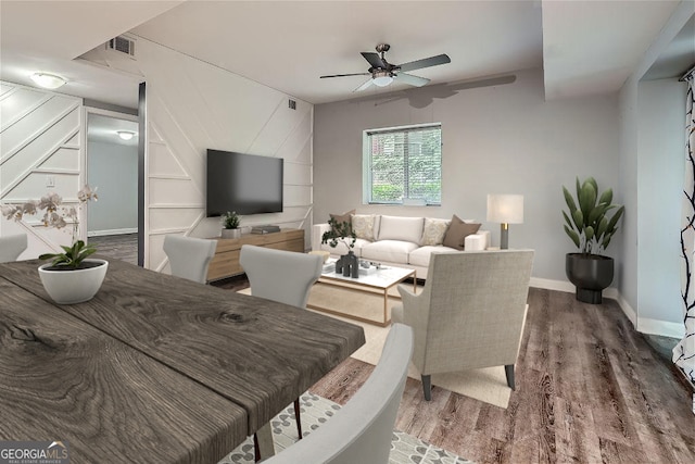 living room featuring wood-type flooring and ceiling fan