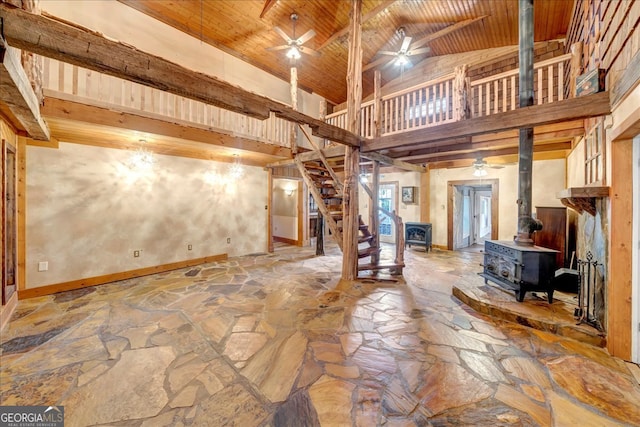 interior space with beamed ceiling, high vaulted ceiling, a wood stove, and wood ceiling