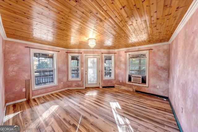 empty room with light wood-type flooring, ornamental molding, and wood ceiling